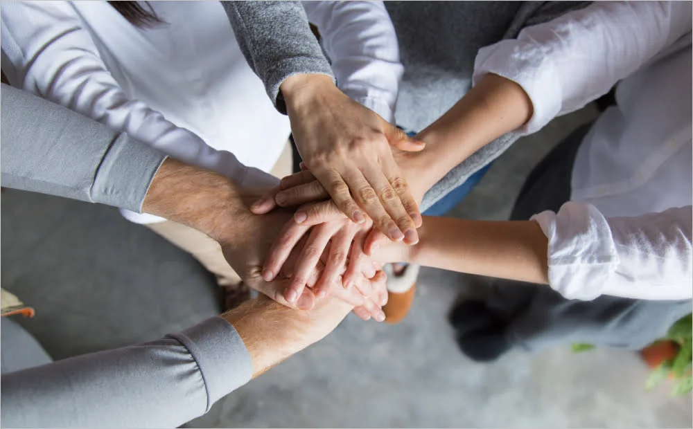 office workers uniting hands