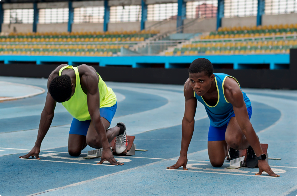 two black runners on blocks ready to race