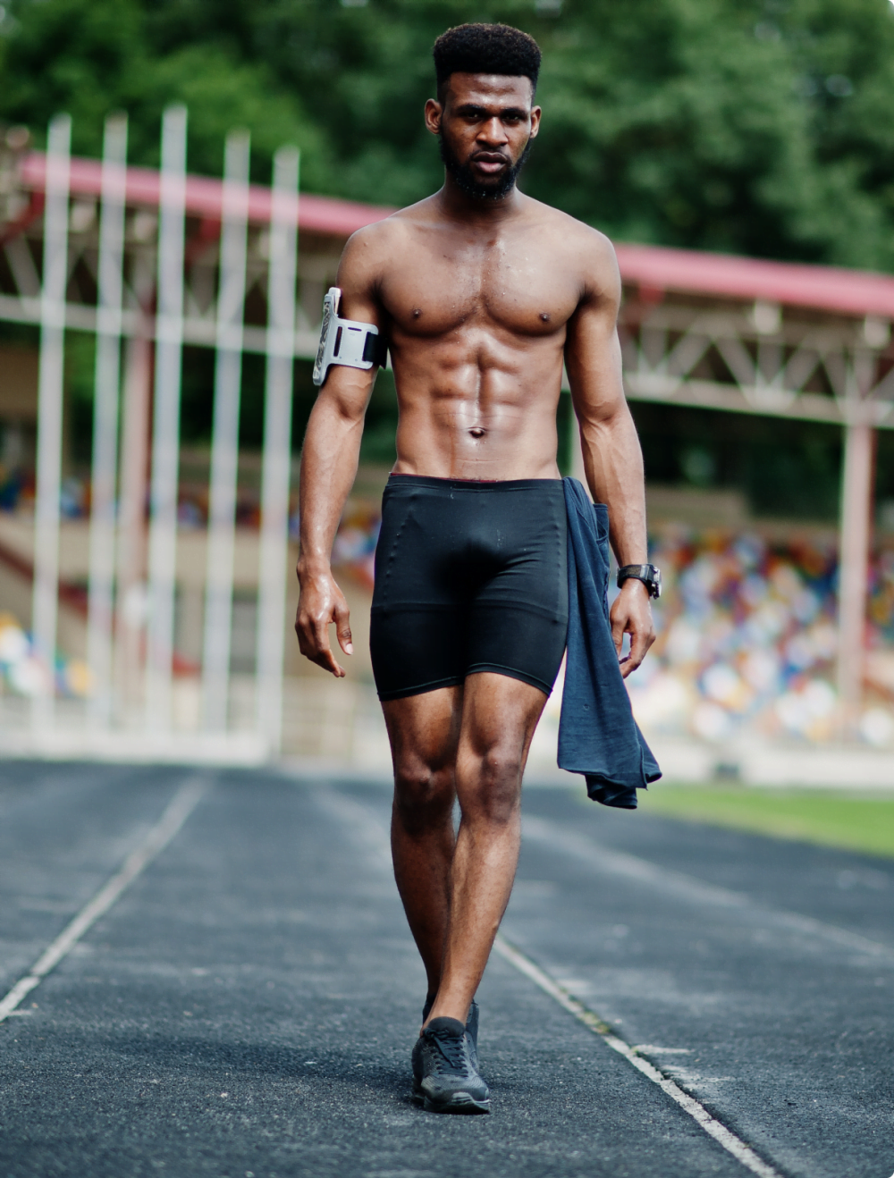 black shirtless athlete on track