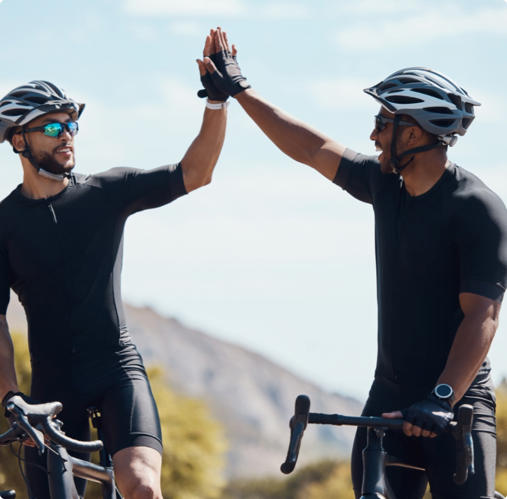 male cyclists high fiving