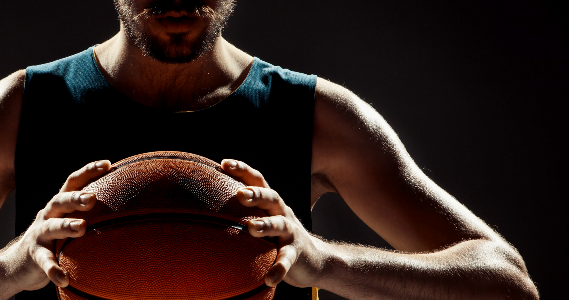 male athlete holding basketball