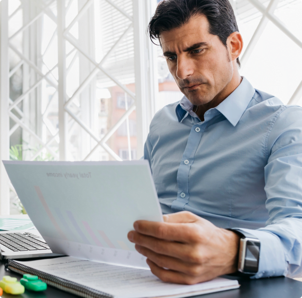 man in office looking at chart