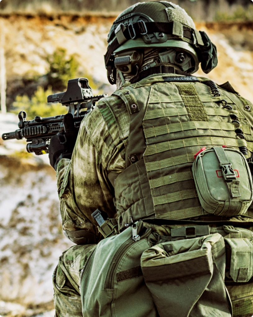 back of soldier aiming rifle