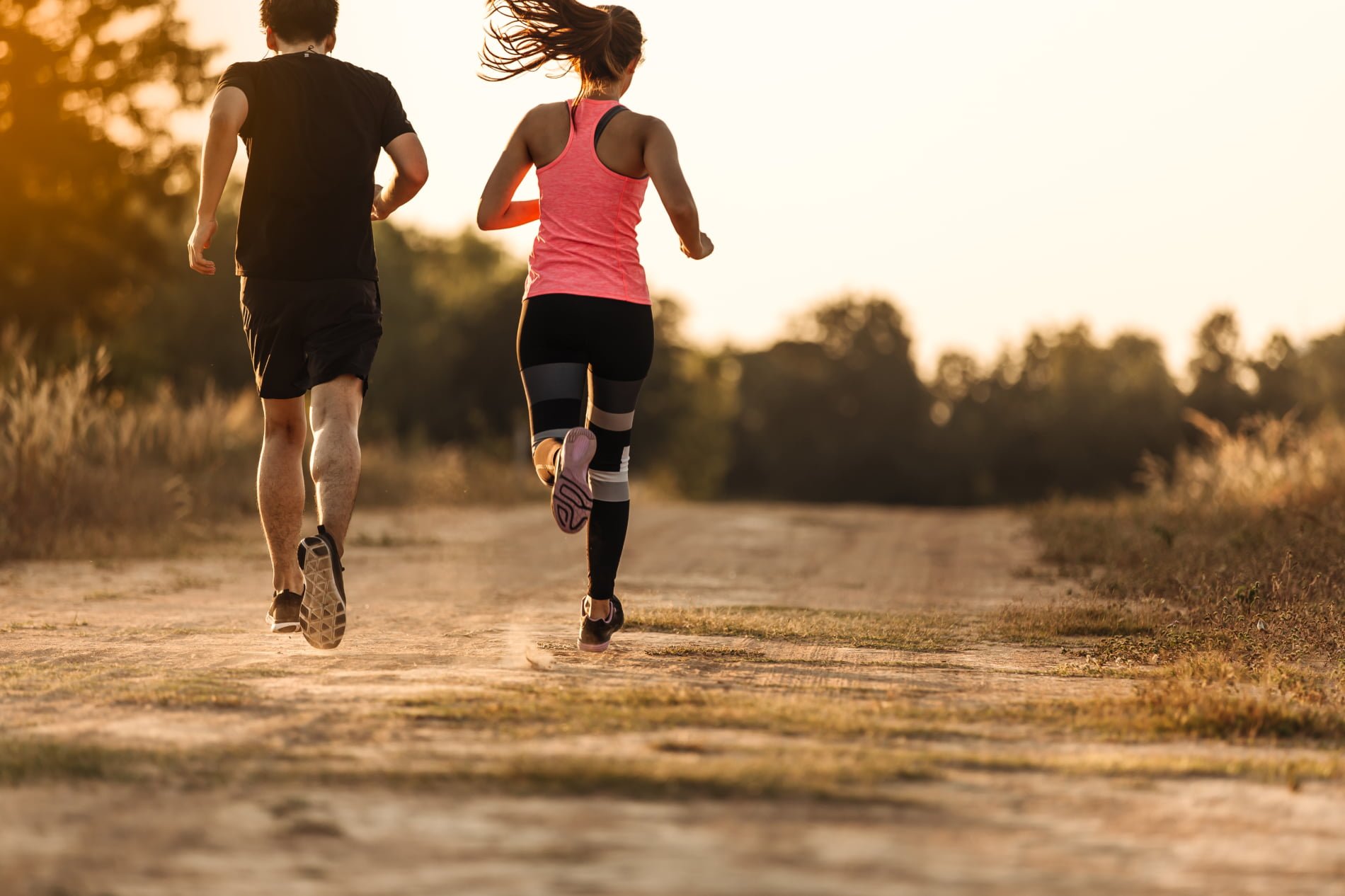 male and female runner on dirt road