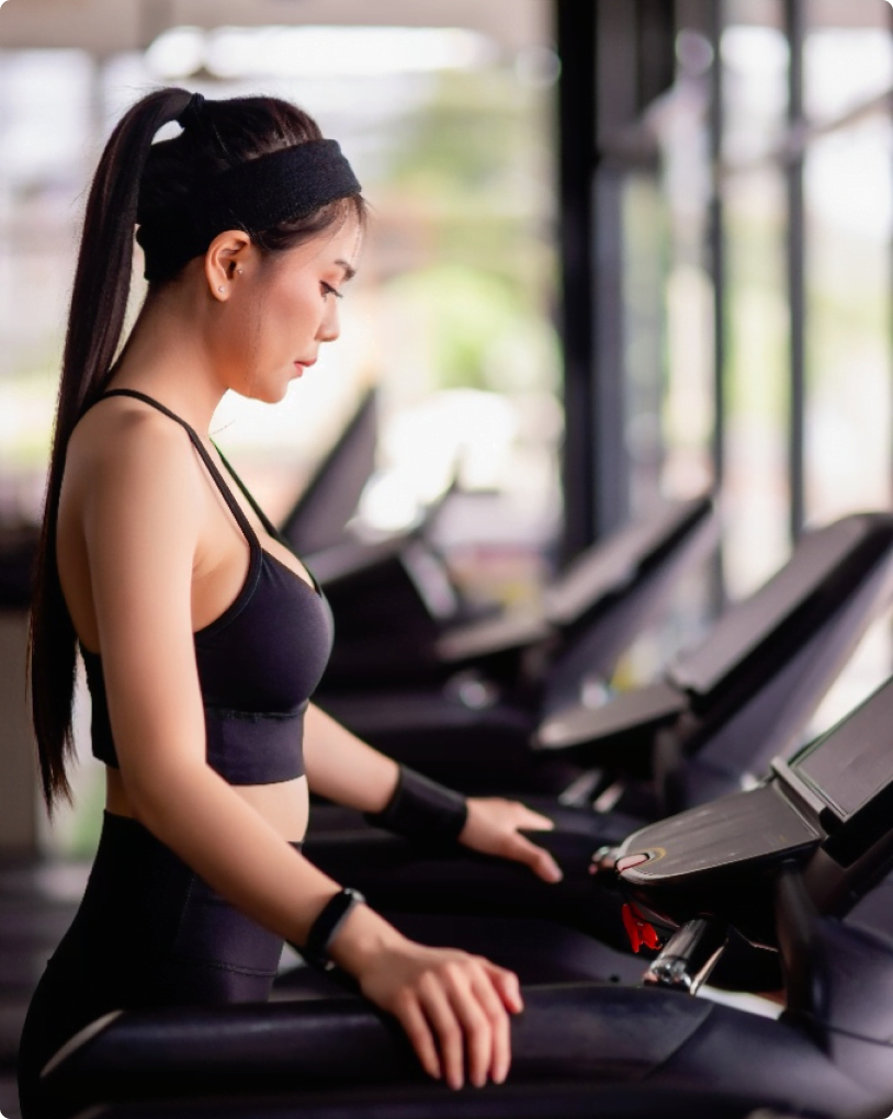 Asian woman running on treadmill