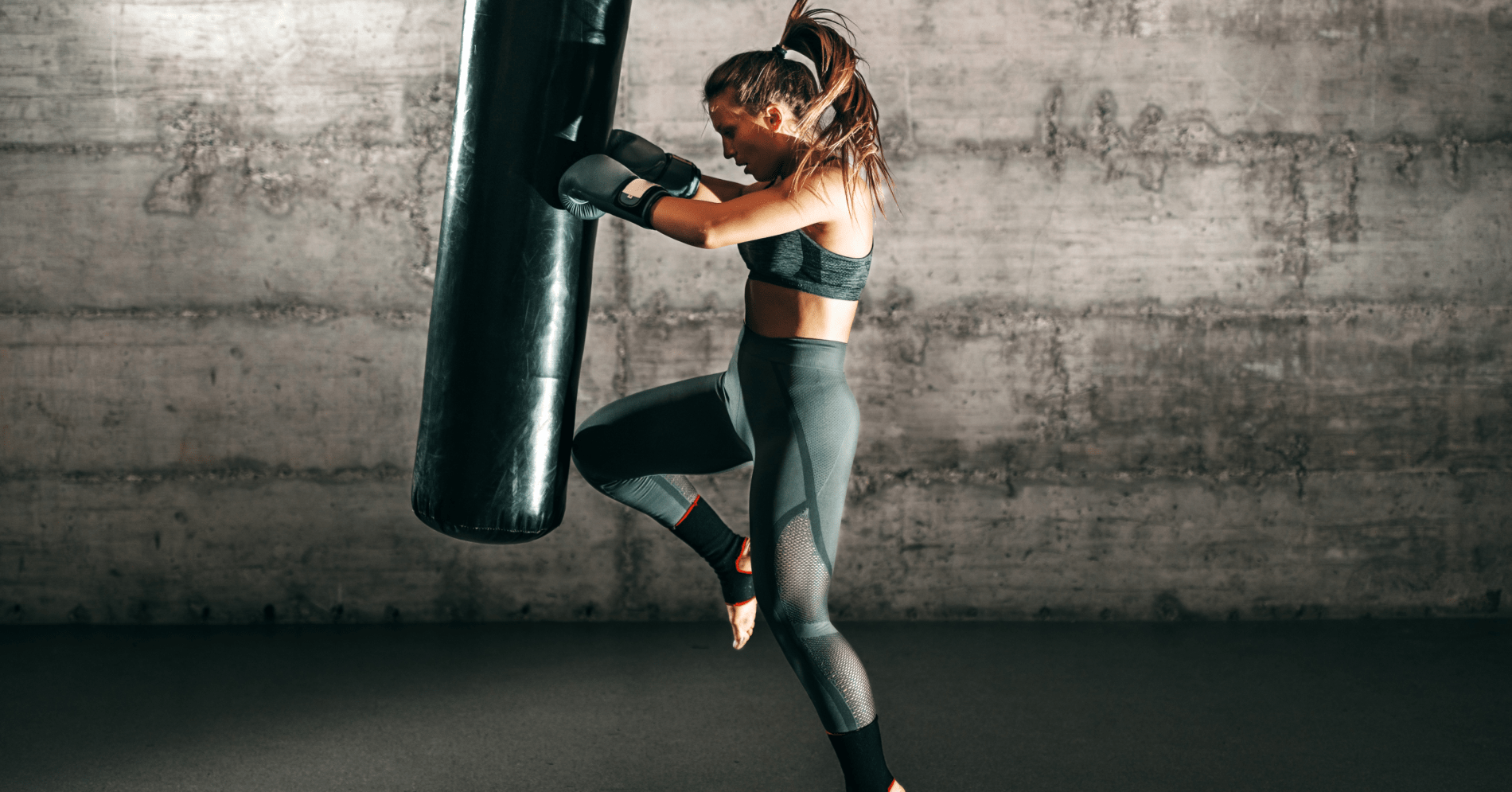 woman punching hanging bag