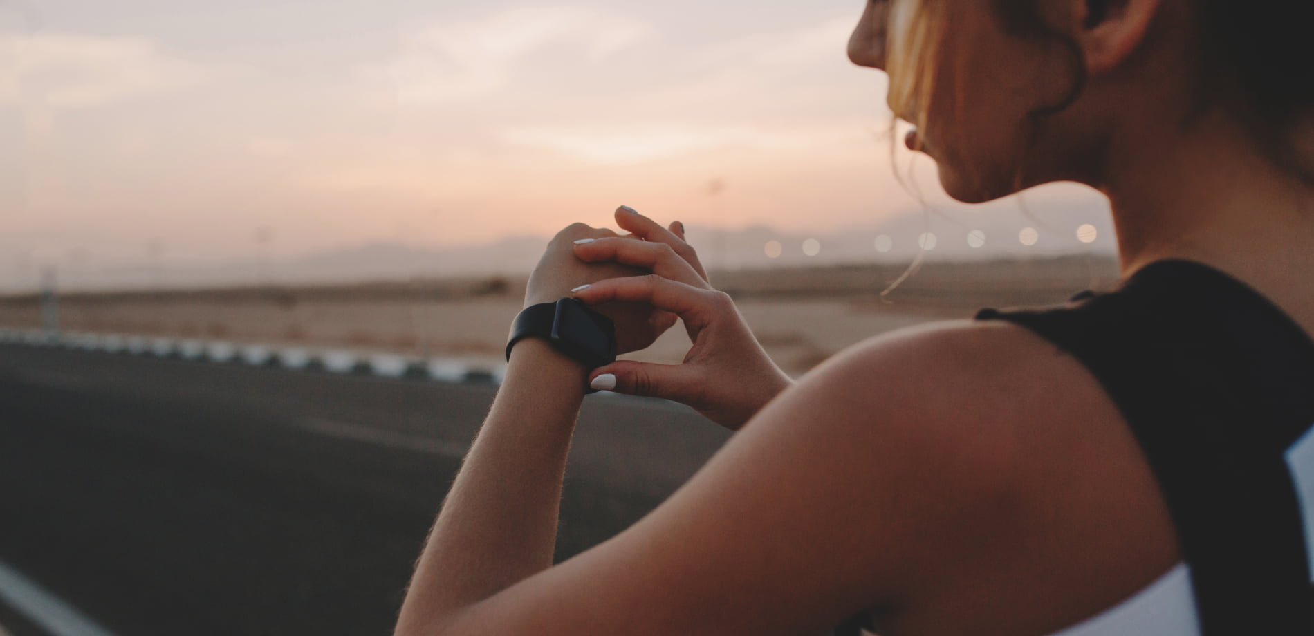 female athlete looking at sports watch