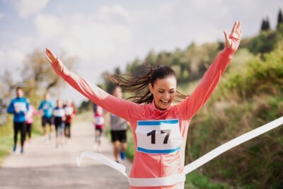 woman runner crossing finish line